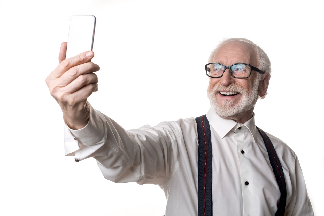 Older man taking a selfie